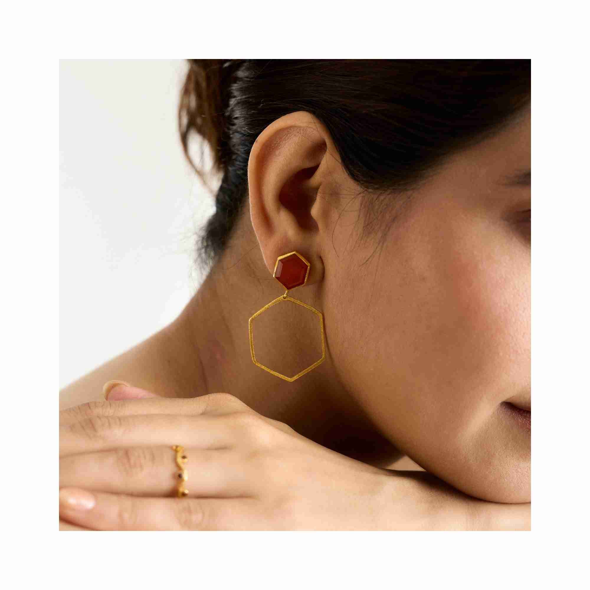Detail shot of Geo Glam Hexagonal Carnelian Statement Earrings Gold — hand-textured gold post with orange carnelian gemstone by Protsaah Zurich.