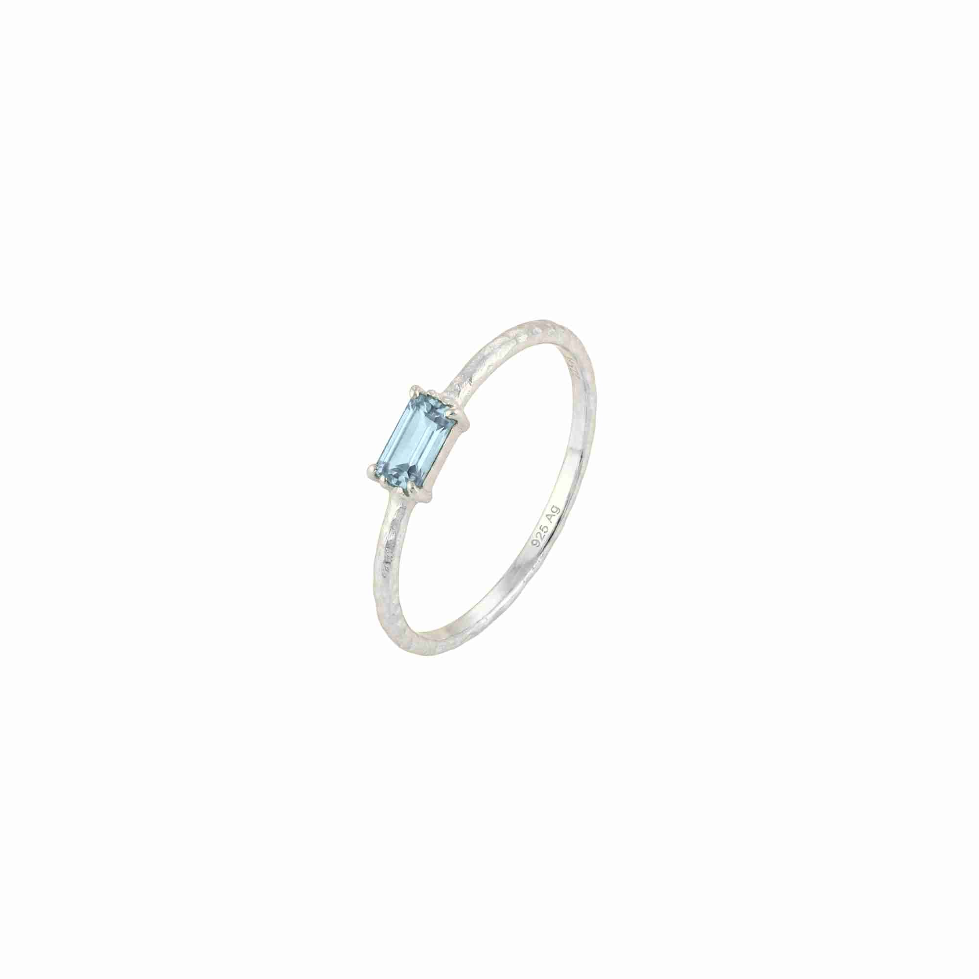 Delicate Vintage Blue Topaz Baguette Ring Silver — an adjustable 92.5 sterling silver bypass ring featuring a horizontally set step-cut baguette blue topaz on a 1.3 mm hammered texture band by Protsaah Zurich.