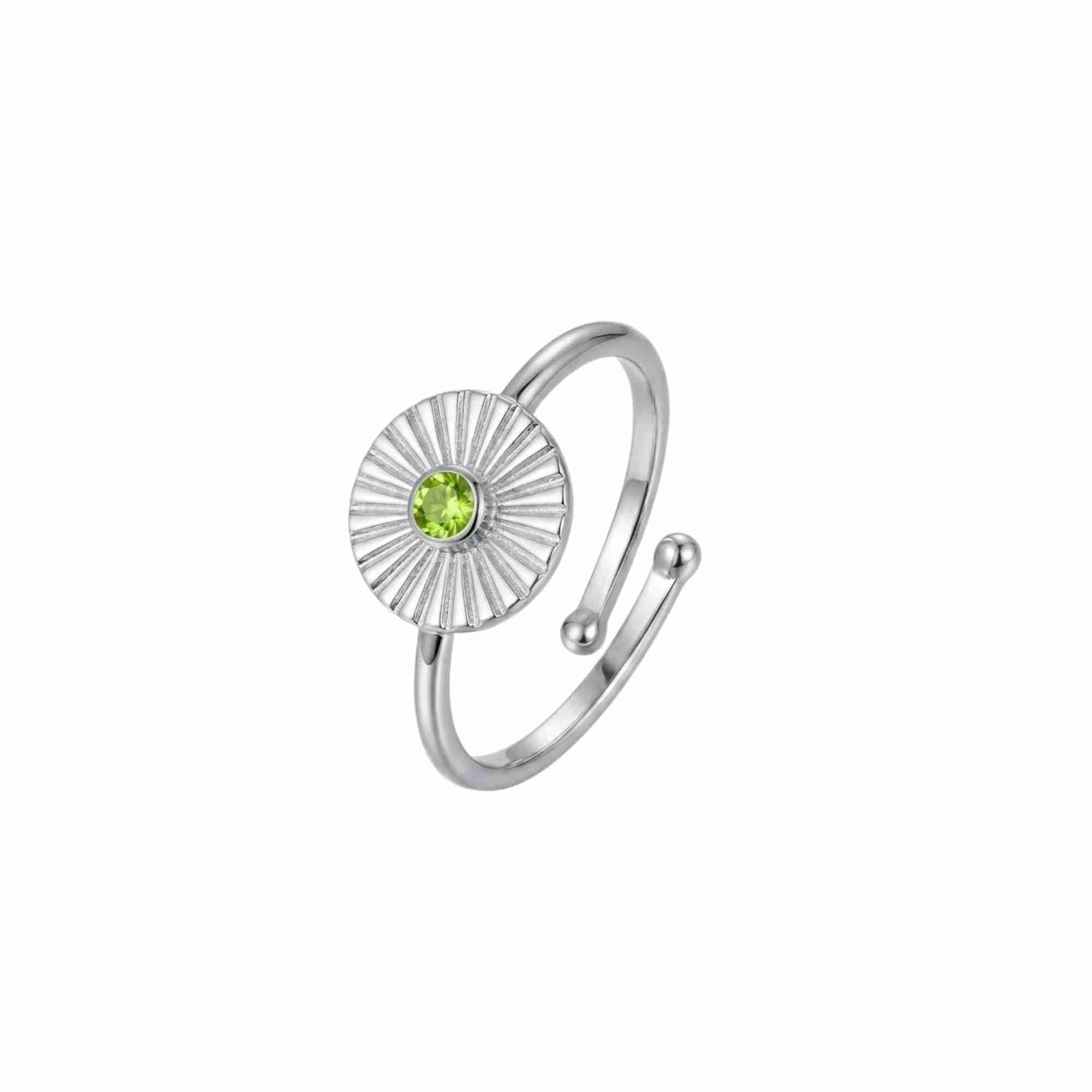 Three-quarter angled view of Delicate Vintage Peridot Fluted Medallion Coin Ring in 925 silver, featuring a sunburst fluted coin medallion set with a round green peridot gemstone on an open adjustable band.