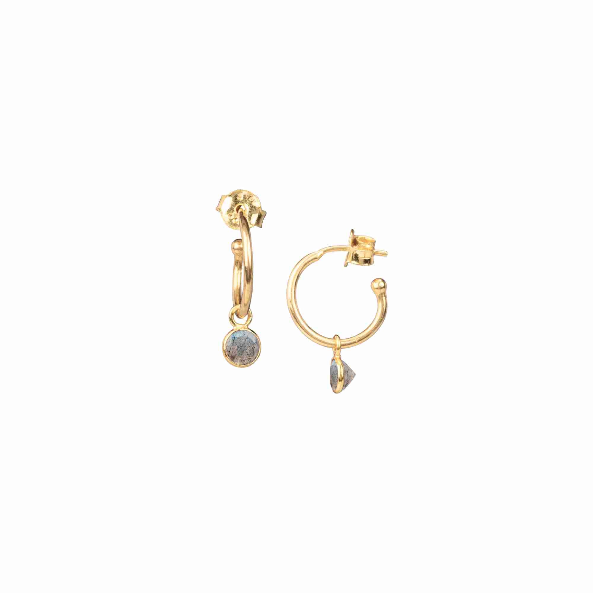 Product picture named Dew Drops displaying a front view and side profile view of the Hoop Earrings with Labradorite Charm Gold against a plain white background, showcasing a pair of delicate, polished 22K gold vermeil huggie hoops with dangling bezel-set round-cut natural Labradorite gemstone charms displaying an iridescent blue-grey flash and secure post-and-butterfly back closures by Protsaah Zurich.