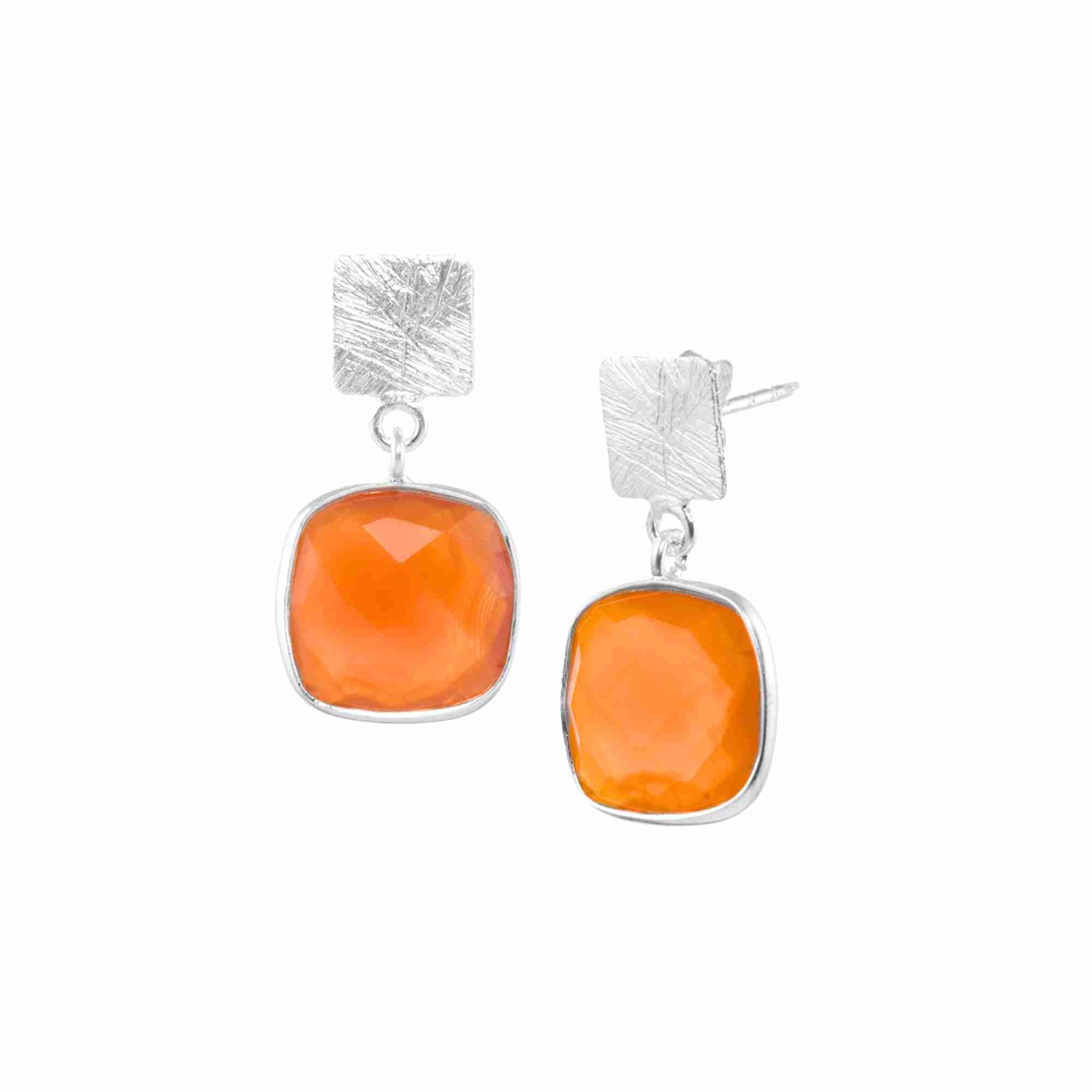 Product photography of Geo Glam Cushion-Cut Orange Chalcedony Drop Earrings Silver, highlighting the faceted square orange gemstone with rounded corners suspended from a hand-textured matte 92.5 recycled silver square post — Protsaah Zurich.
