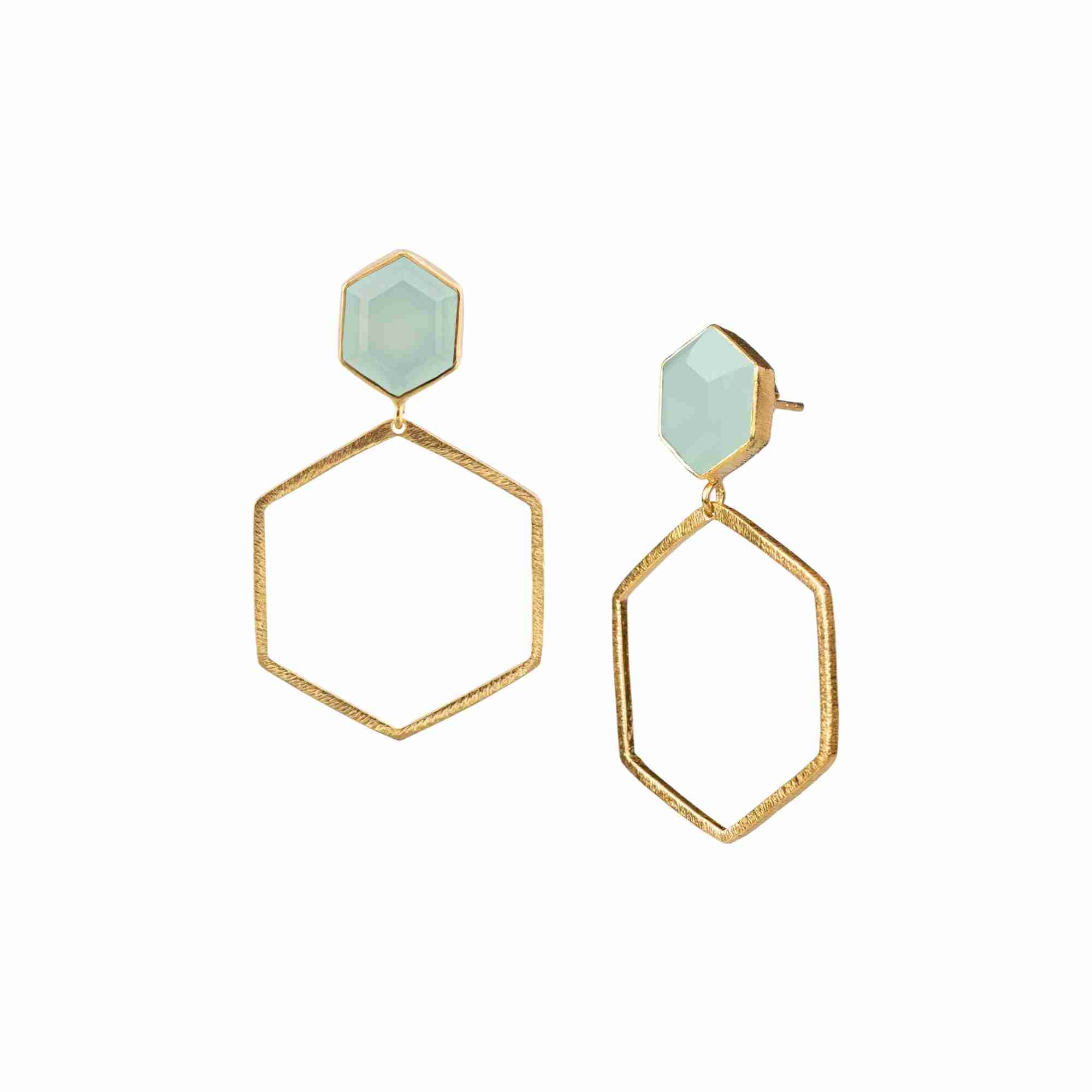 Product photography of Geo Glam Hexagonal Aqua Chalcedony Statement Earrings Gold, highlighting the faceted pastel blue gemstone suspended inside a large, open hexagonal drop frame below a hand-textured matte gold post — Protsaah Zurich.