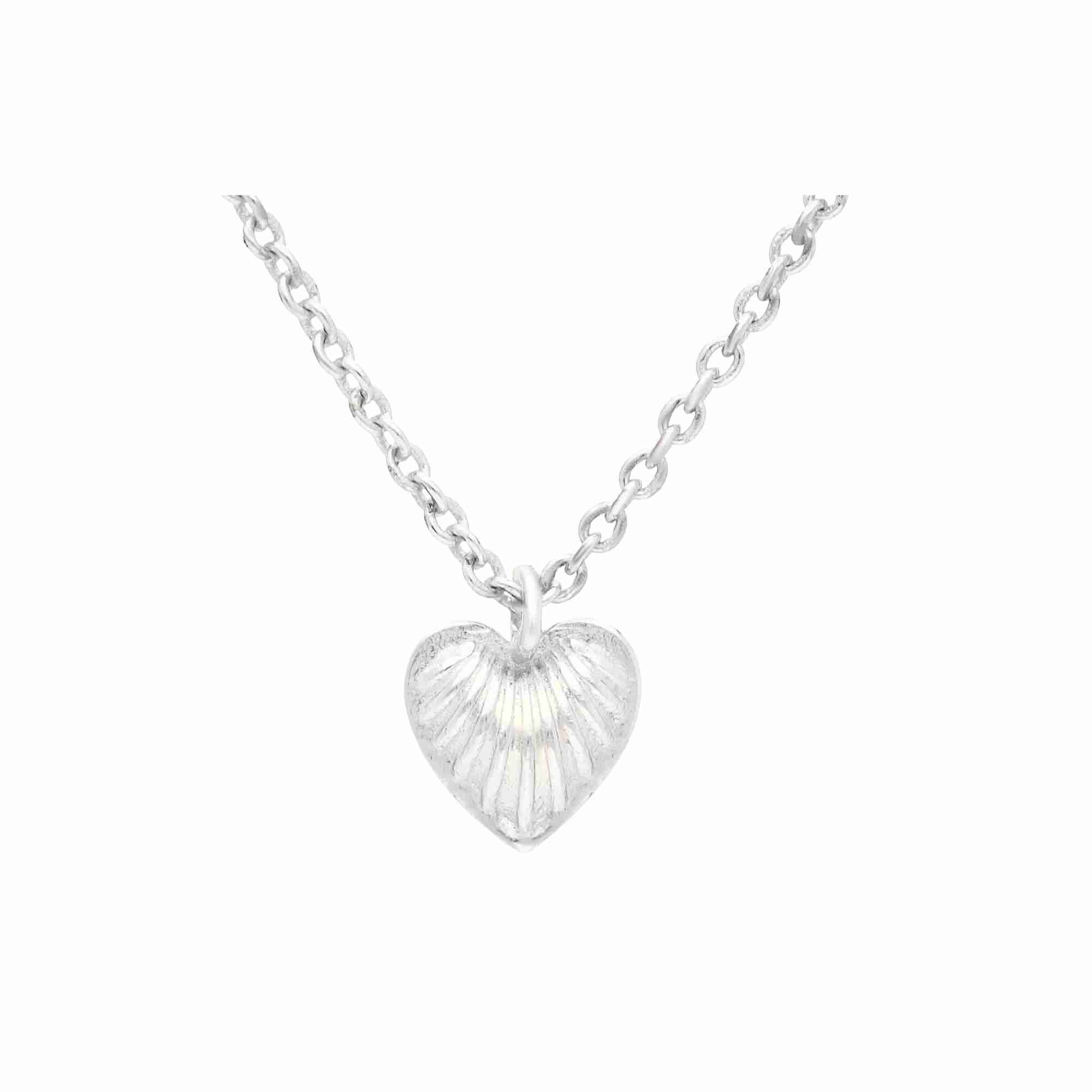 Macro close-up view of the silver Queen of Charms Fluted Heart Pendant Necklace, highlighting the shell-like fluted texture of the heart charm and fine chain detail.