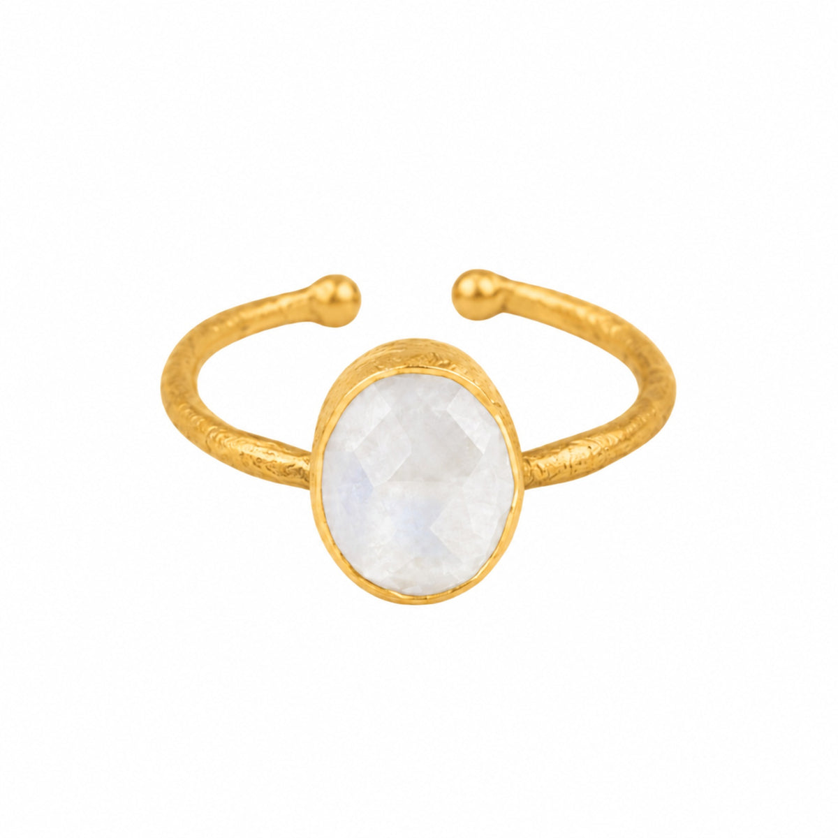 Faceted rainbow moonstone oval in a brushed gold collet on a hammered open gold band on a white background