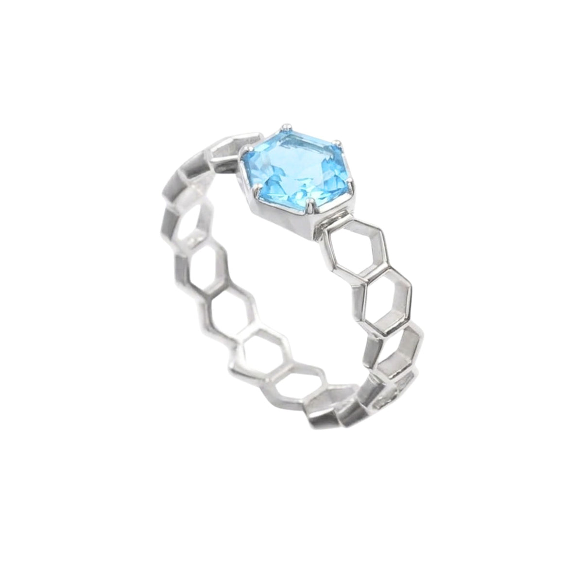 Three-quarter view of the silver honeycomb band ring with a hexagon-cut blue topaz raised in six claws