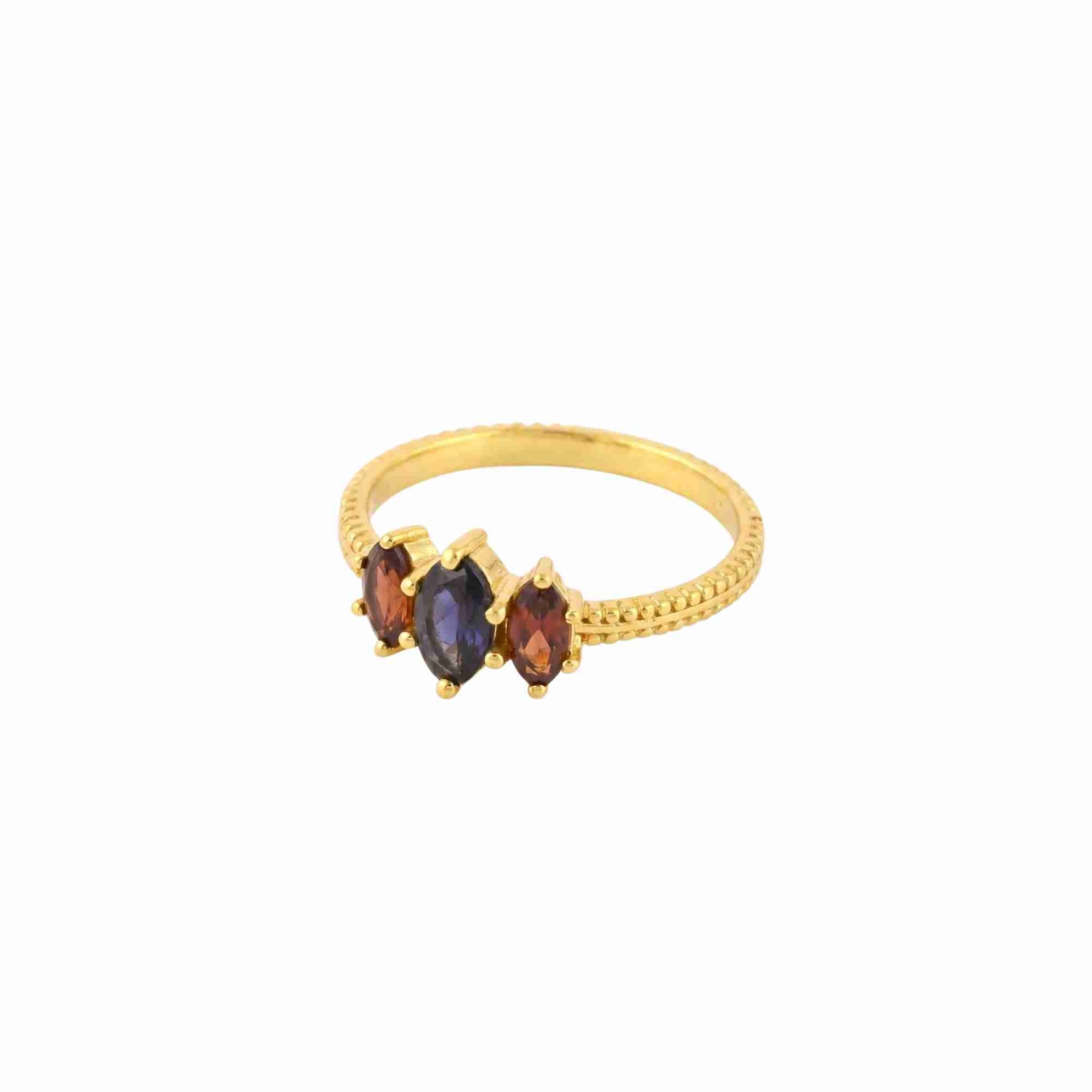 Close-up of Kaleidoscope Iolite and Garnet Three-Stone Marquise Ring Gold — marquise iolite and garnet stones in 22K gold vermeil by Protsaah Zurich.