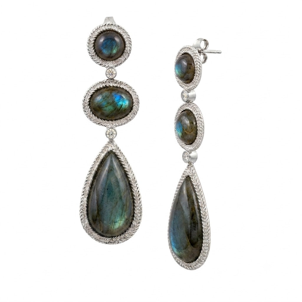 Three linked labradorite cabochons in rope-twist bezels in silver on a white background