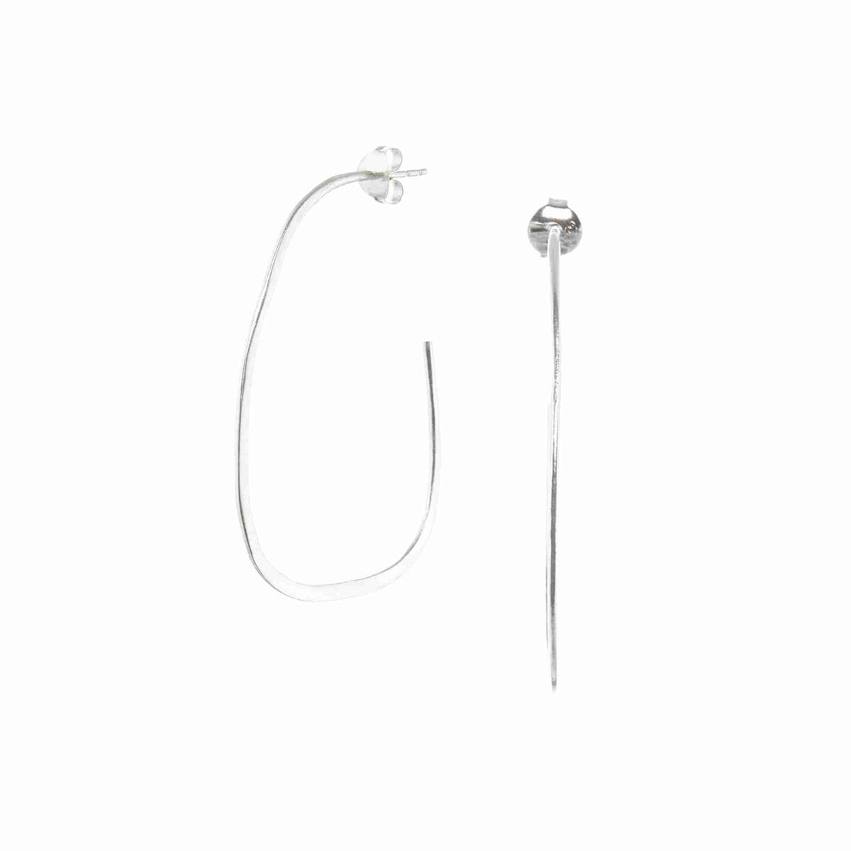 Fine hand-formed organic oval hoop earrings in silver on a white background