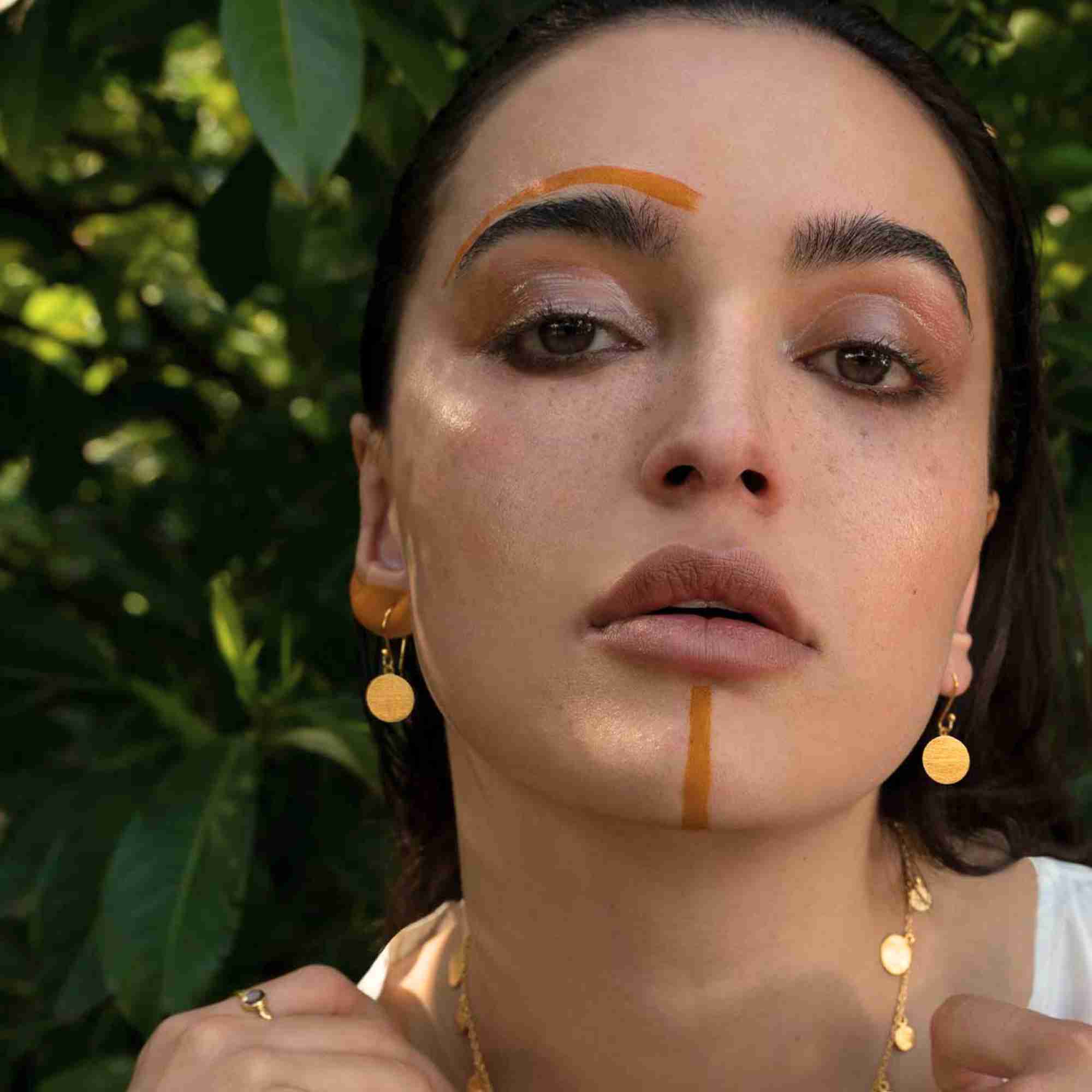 Front close-up view of Shimmering Disks Minimalist Coin Drop Earrings Medium Gold resting flat, showcasing the contemporary geometric coin drop profile and handcrafted scratch-finish detail.