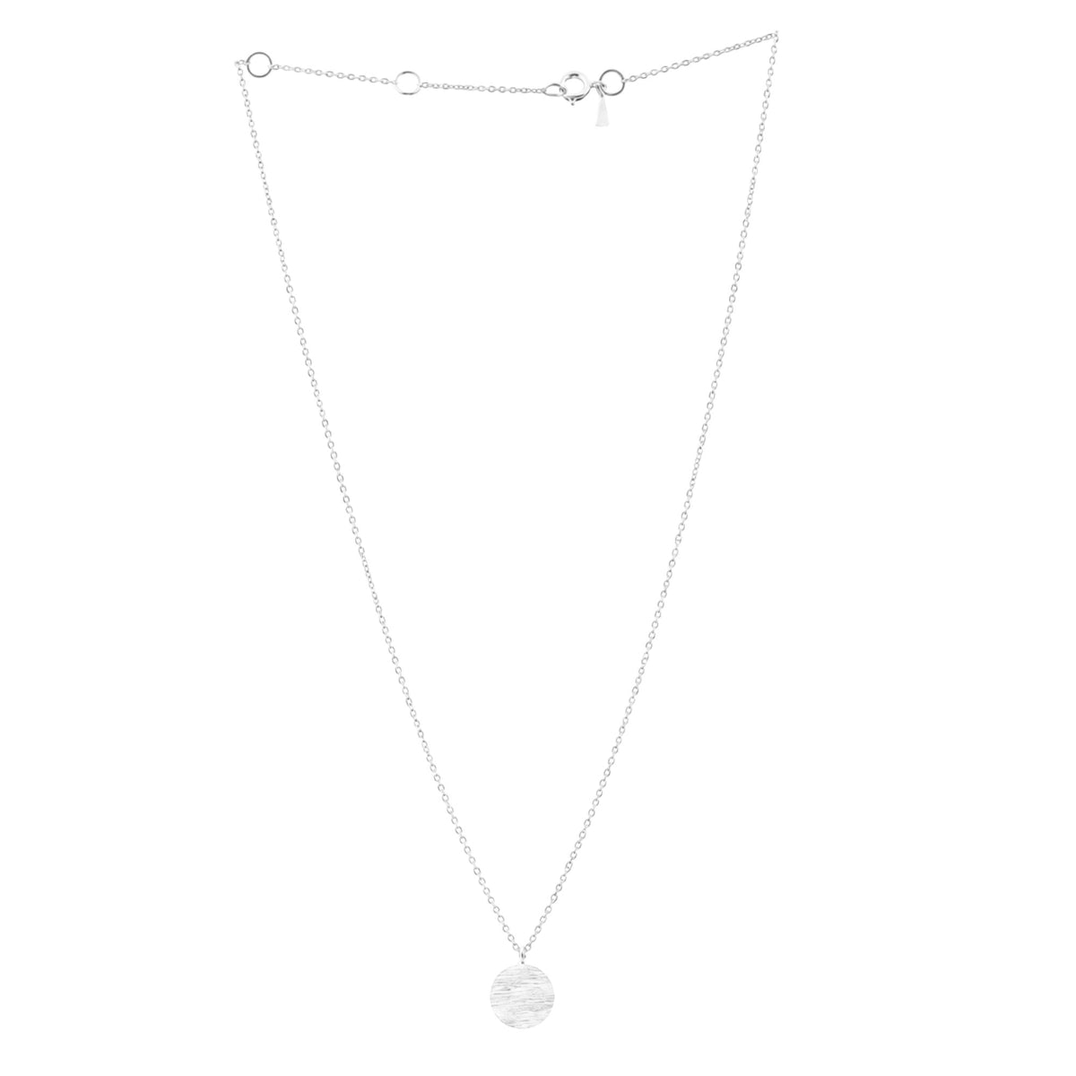 Minimalist coin pendant necklace in silver with a single hand-brushed disc on a white background