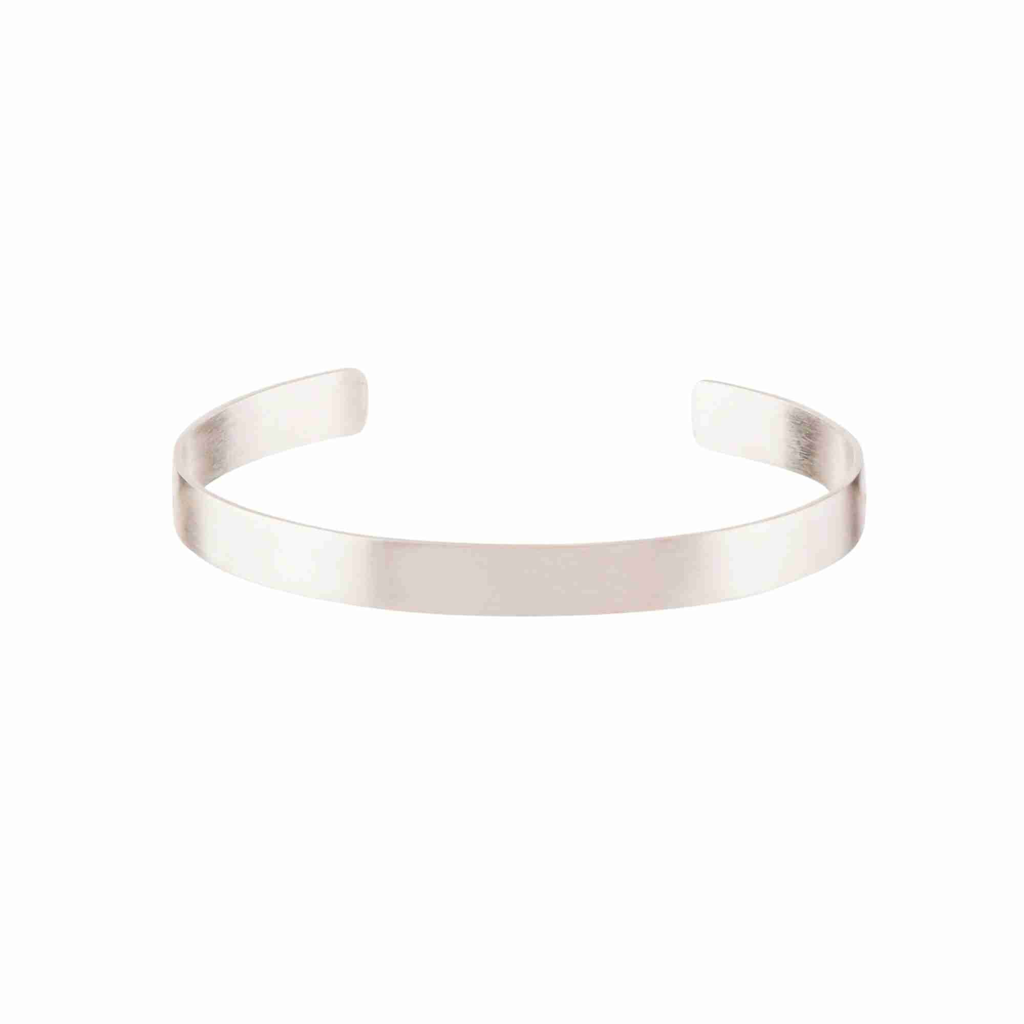 Product picture named ShimmeringDisksSignatureFlat-BandCuffSilver showing the Shimmering Disks Signature Flat-Band Cuff Silver against a solid white background, highlighting its minimalist open-back design and sleek, hand-brushed matte sterling silver finish by Protsaah Zurich.