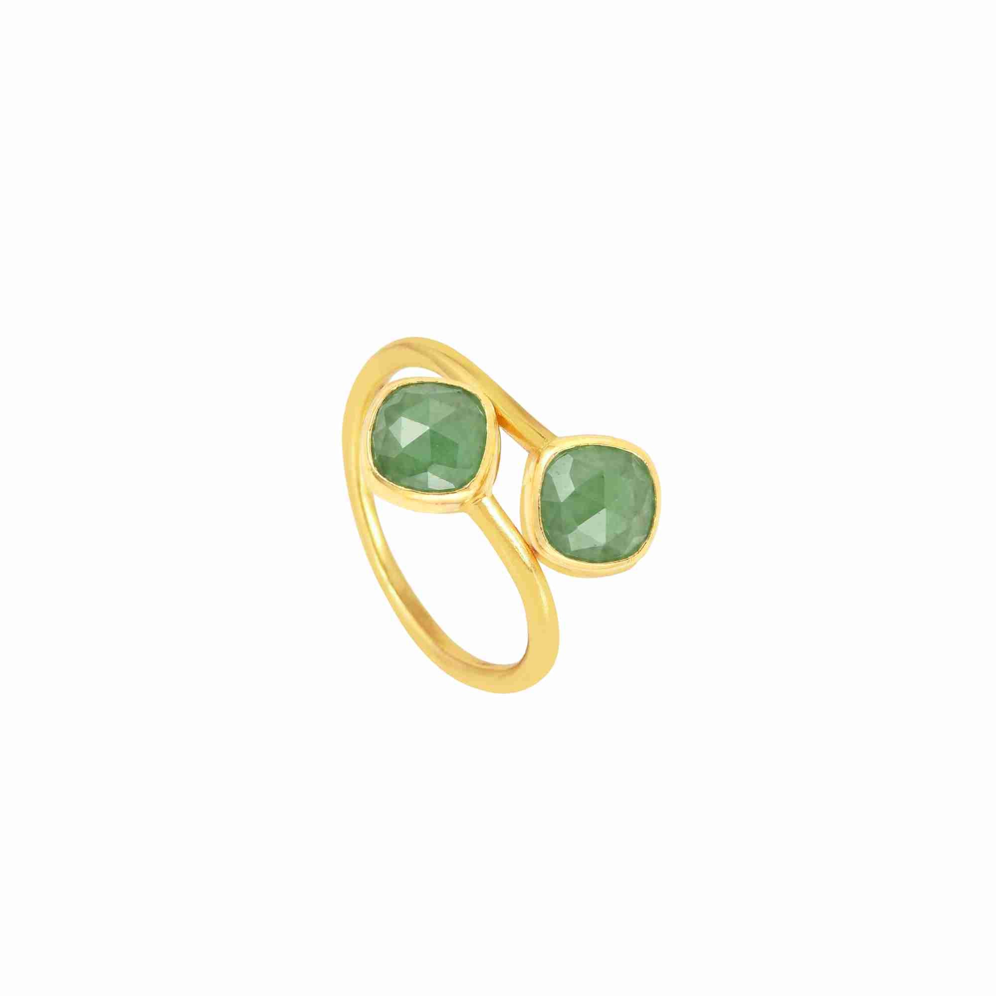 Product picture showing a three-quarter side angle view of the Geo Glam Toi et Moi Nephrite Ring Gold on a white background. The 22K gold vermeil bypass band holds two cushion-cut green Nephrite jade gemstones facing each other in a contemporary wrap design by Protsaah Zurich.