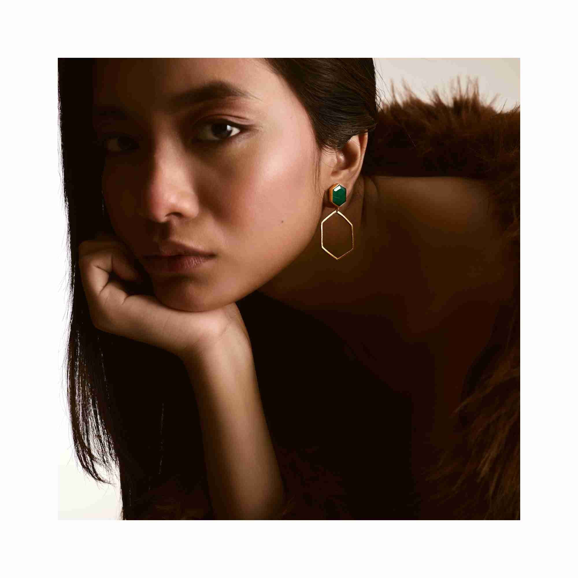 Lifestyle shot of Geo Glam Hexagonal Labradorite Statement Earrings Gold — hexagonal drop earrings with iridescent labradorite stone in 22K gold vermeil by Protsaah Zurich.