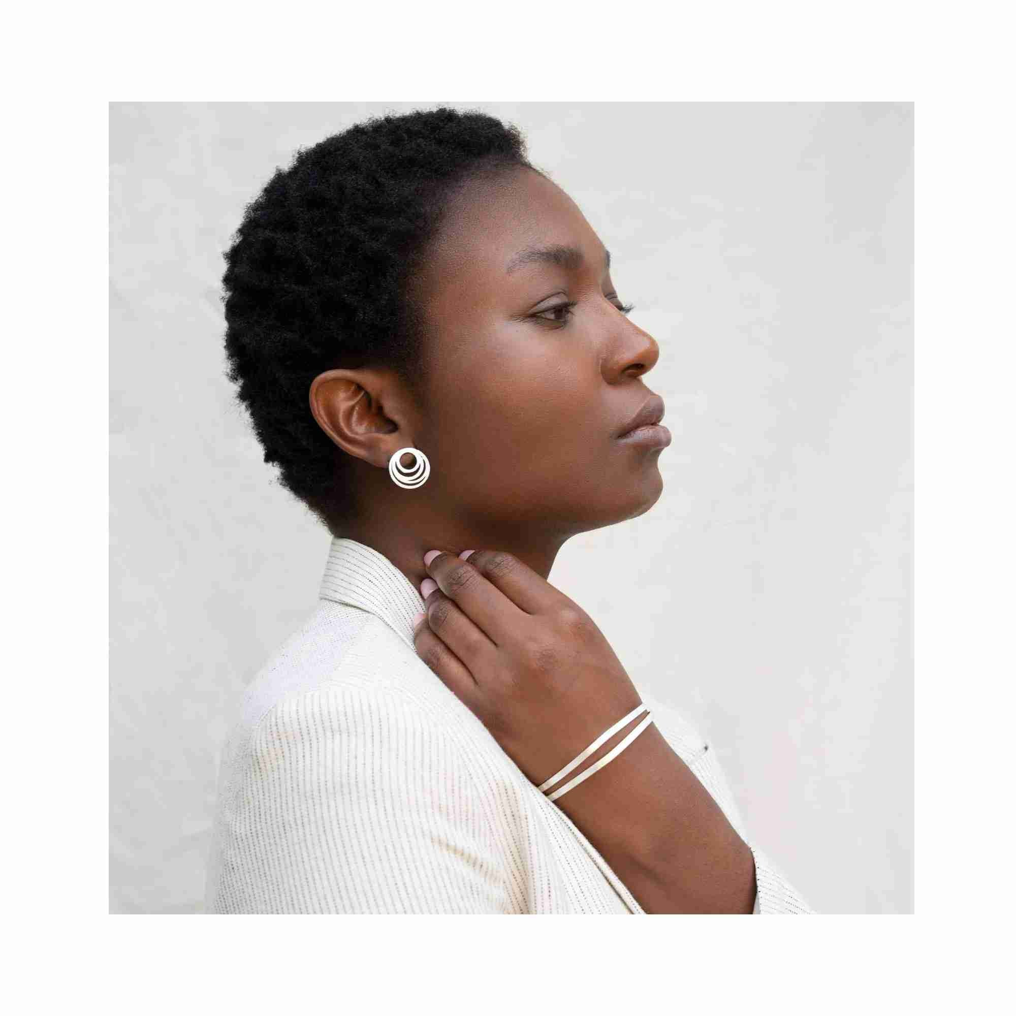 Technical product photoshoot of the Shimmering Disks Sculptural Flat-Band Double Cuff Silver, showcasing the sleek dual-band architectural silhouette and artisan hand-applied scratch finish on 92.5 recycled silver — Protsaah Zurich.