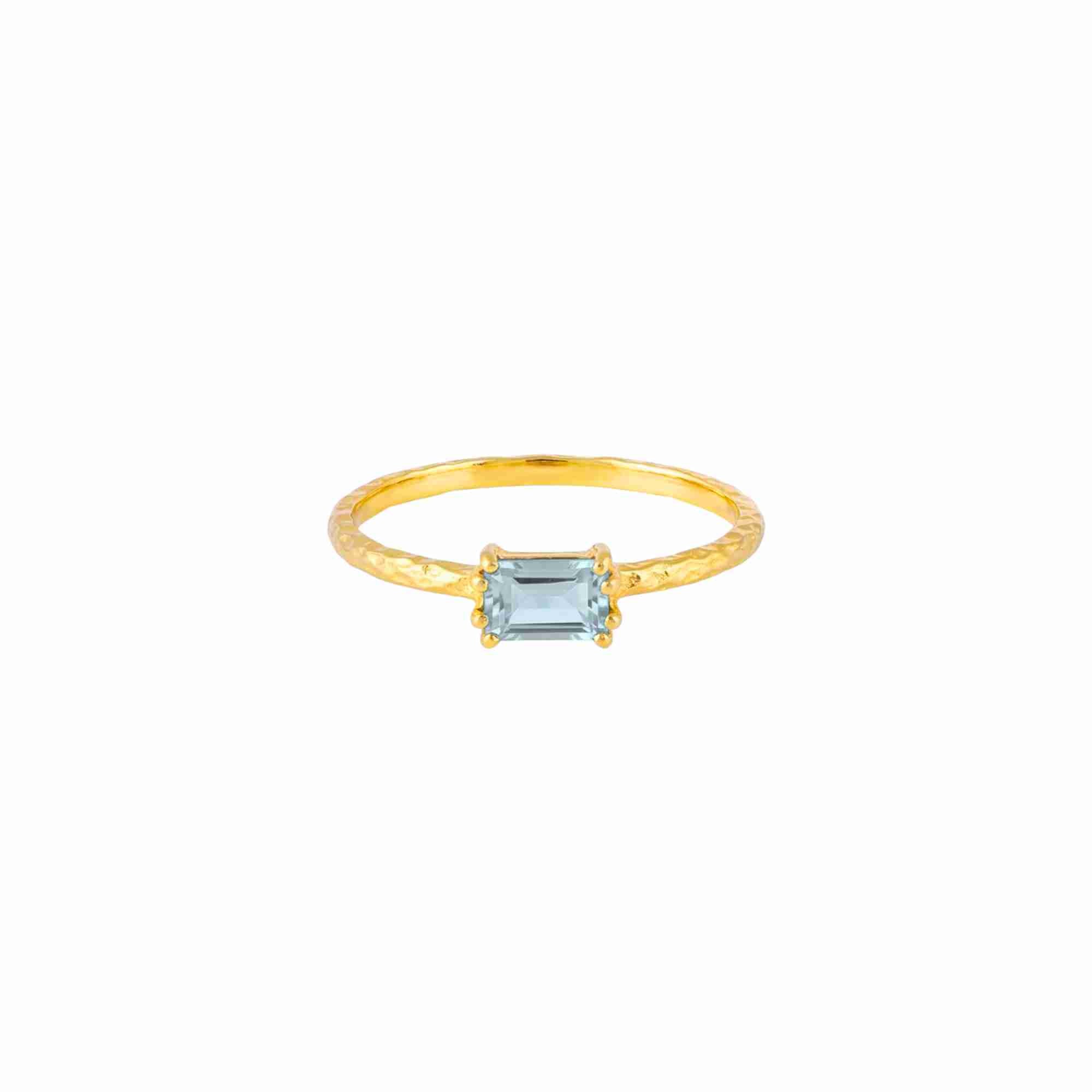 Delicate Vintage Blue Topaz Baguette Ring Gold — an adjustable 22K gold vermeil bypass ring featuring a horizontally set step-cut baguette blue topaz on a 1.3 mm hammered texture band by Protsaah Zurich.