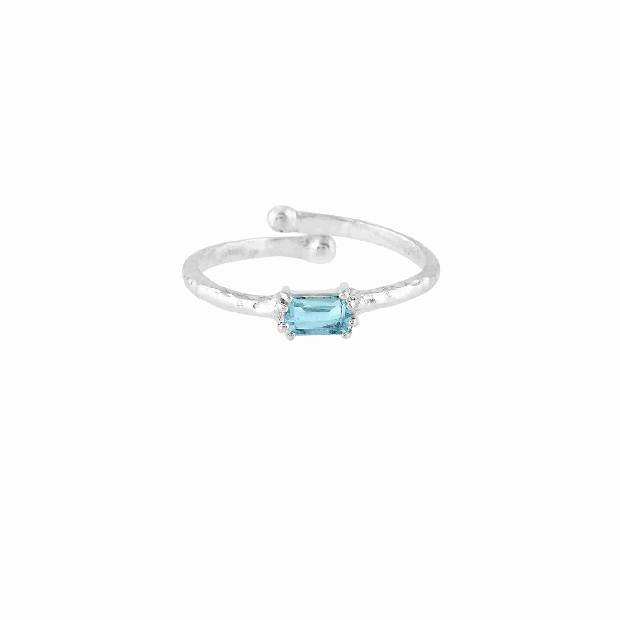 Delicate Vintage Blue Topaz Baguette Ring Silver — an adjustable 92.5 sterling silver bypass ring featuring a horizontally set step-cut baguette blue topaz on a 1.3 mm hammered texture band by Protsaah Zurich.