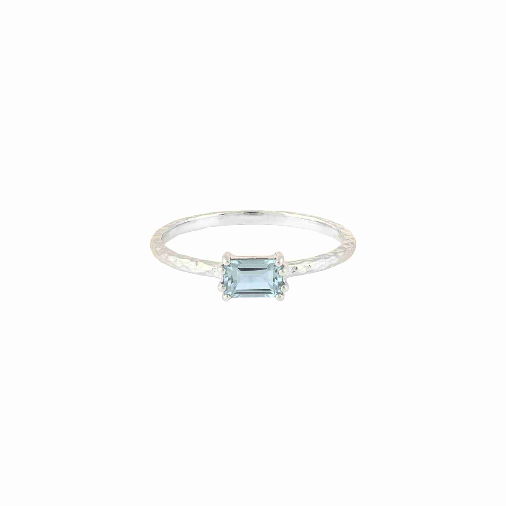 Delicate Vintage Blue Topaz Baguette Ring Silver — an adjustable 92.5 sterling silver bypass ring featuring a horizontally set step-cut baguette blue topaz on a 1.3 mm hammered texture band by Protsaah Zurich.