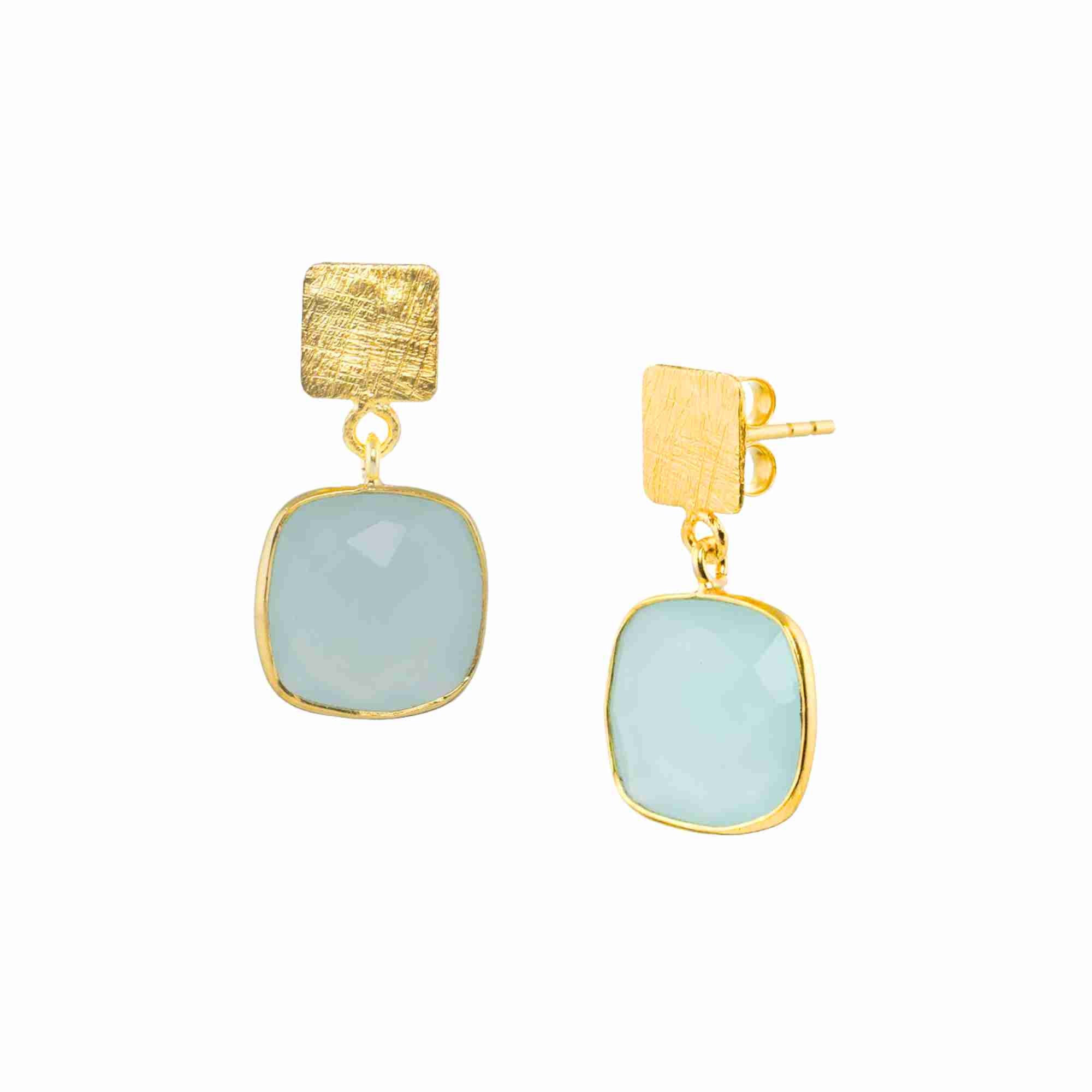 Product photography of Geo Glam Cushion-Cut Aqua Chalcedony Drop Earrings Gold, highlighting the faceted square translucent sea-foam blue gemstone suspended from a hand-textured matte gold square post — Protsaah Zurich.
