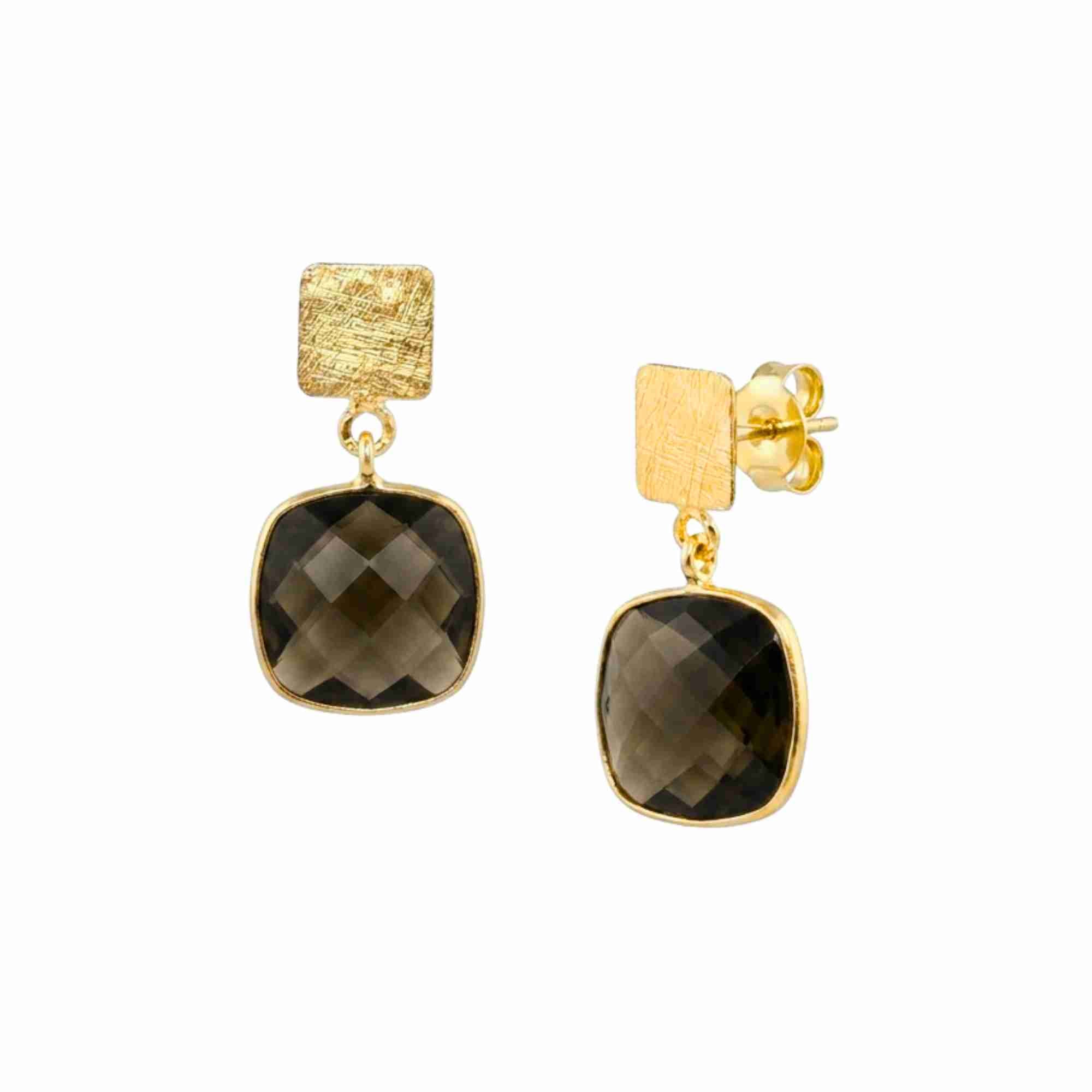 Product photography of Geo Glam Cushion-Cut Smoky Quartz Drop Earrings Gold, highlighting the faceted square translucent brown gemstone suspended from a hand-textured matte gold square post — Protsaah Zurich.