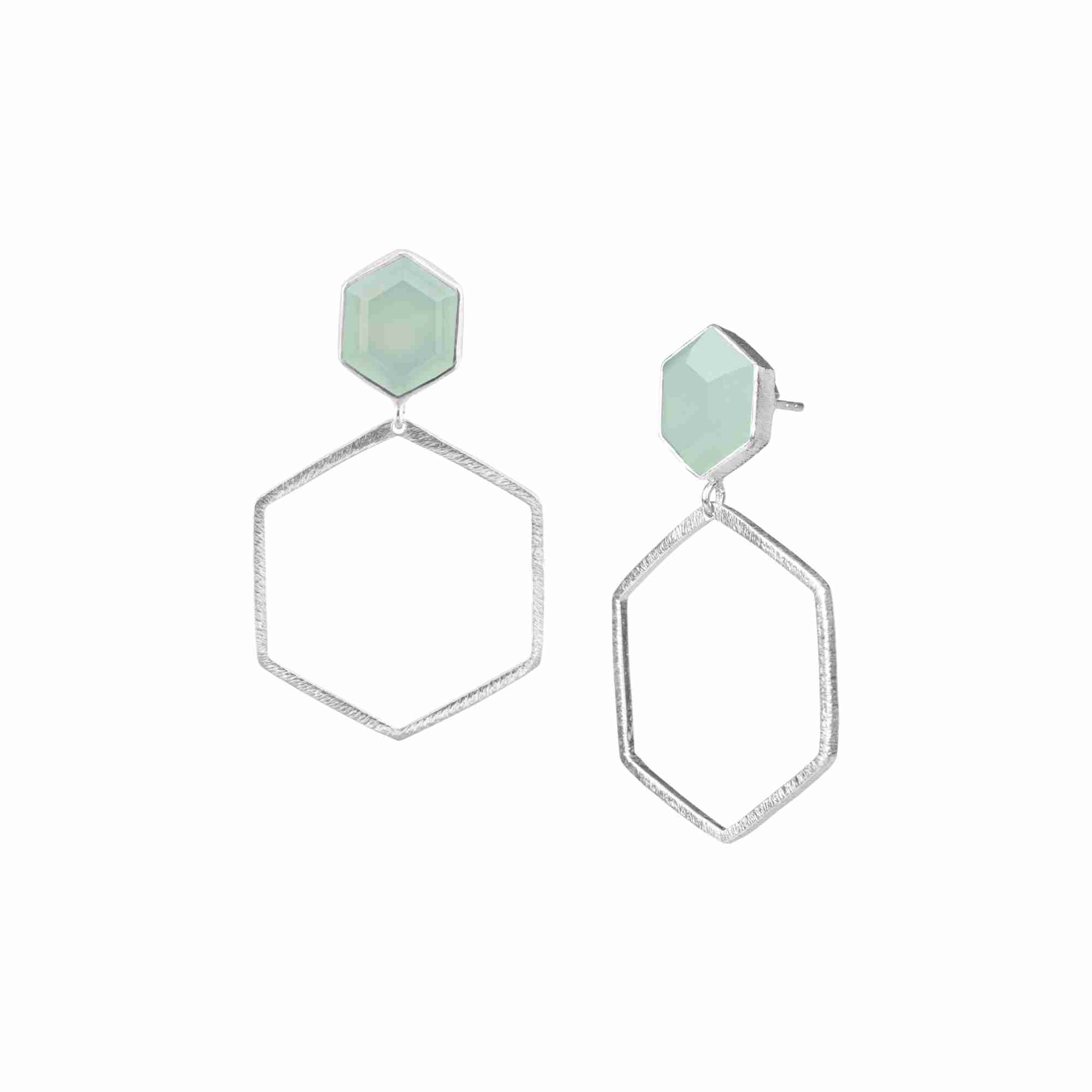 Product photography of Geo Glam Hexagonal Aqua Chalcedony Statement Earrings Silver, highlighting the faceted pastel blue gemstone suspended inside a large, open hexagonal drop frame below a hand-textured matte silver post — Protsaah Zurich.