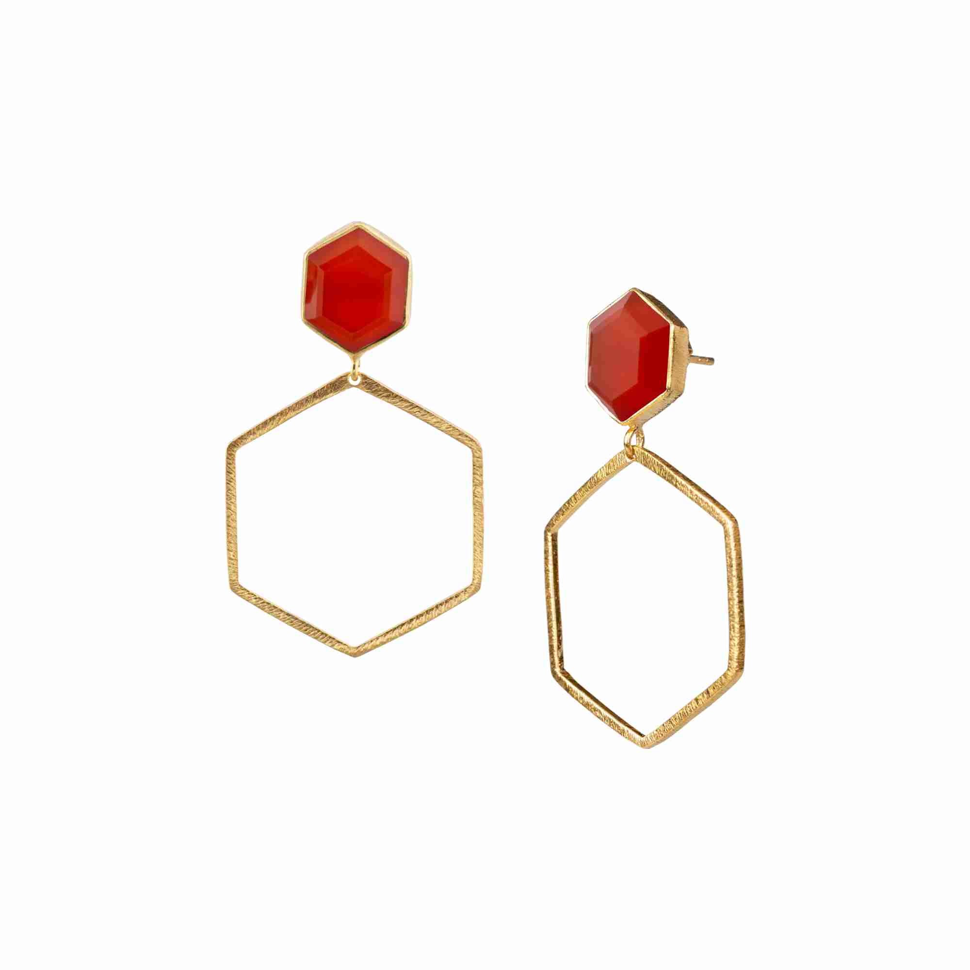 Product photography of Geo Glam Hexagonal Carnelian Statement Earrings Gold, highlighting the faceted orange gemstone suspended inside a large, open hexagonal drop frame below a hand-textured matte gold post — Protsaah Zurich.