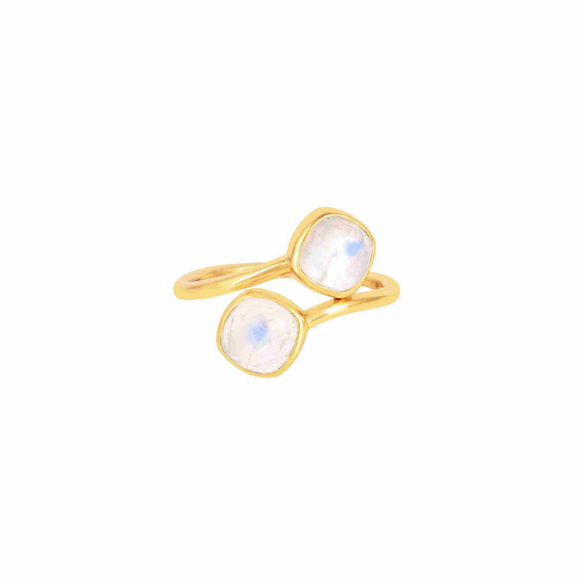 Studio product photography of the Protsaah Geo Glam Toi et Moi Rainbow Moonstone Ring in Gold (SKU: RN-063-AU-RMS), showcasing two cushion-cut glowing milky-white moonstone gemstones with blue flashes on an adjustable open-front gold band.