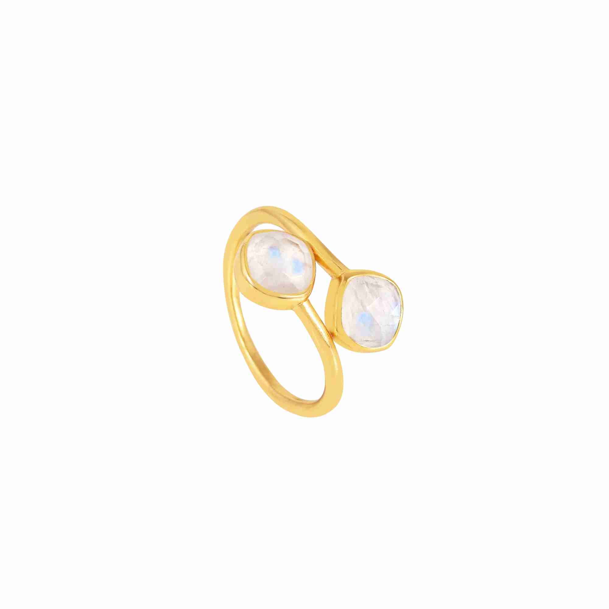 Studio product photography of the Protsaah Geo Glam Toi et Moi Rainbow Moonstone Ring in Gold (SKU: RN-063-AU-RMS), showcasing two cushion-cut glowing milky-white moonstone gemstones with blue flashes on an adjustable open-front gold band.