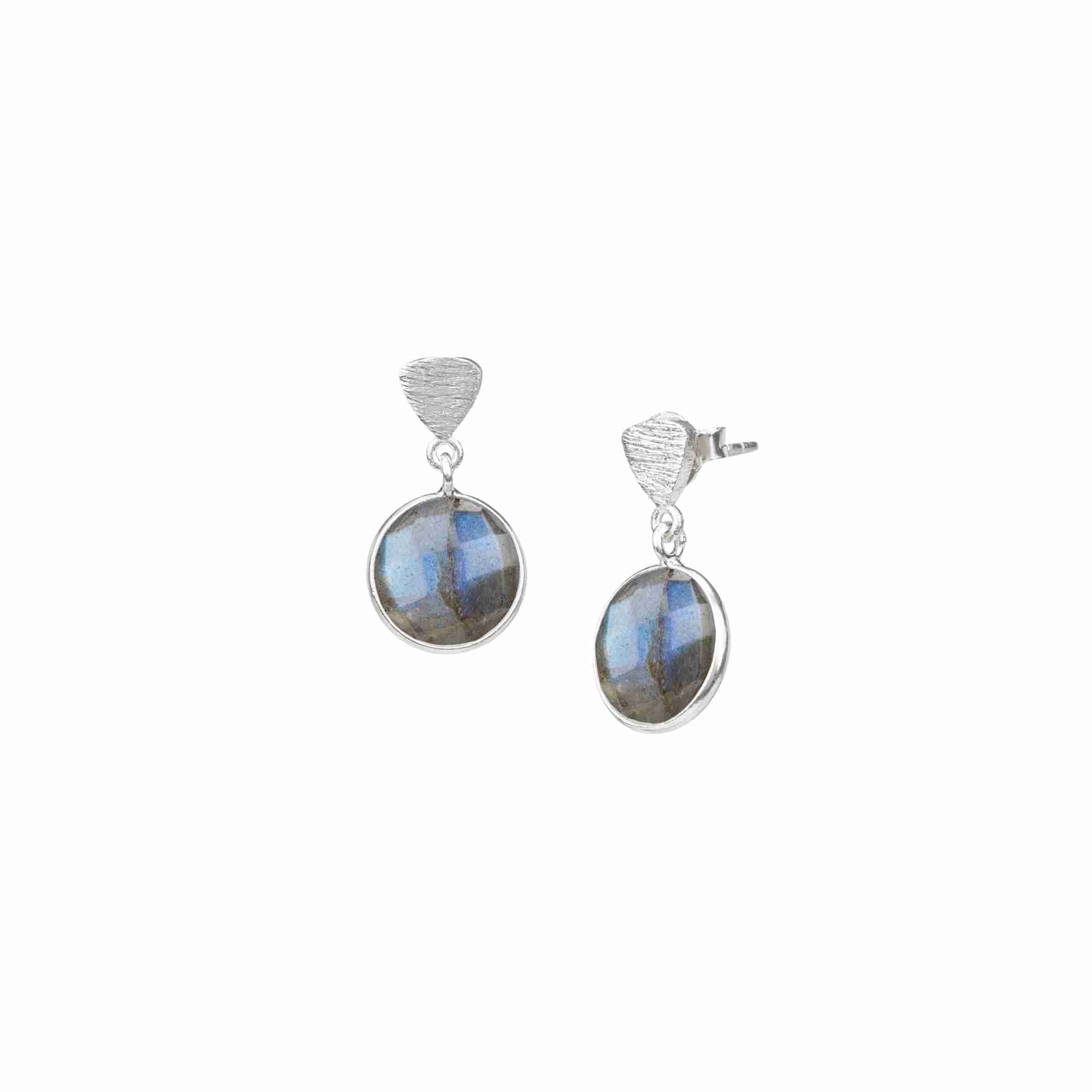 Product photography of Geo Glam Triangle Textured Labradorite Drop Earrings Silver, highlighting the faceted round smoky grey gemstone with blue flashes suspended from a hand-textured matte sterling silver triangular post — Protsaah Zurich.