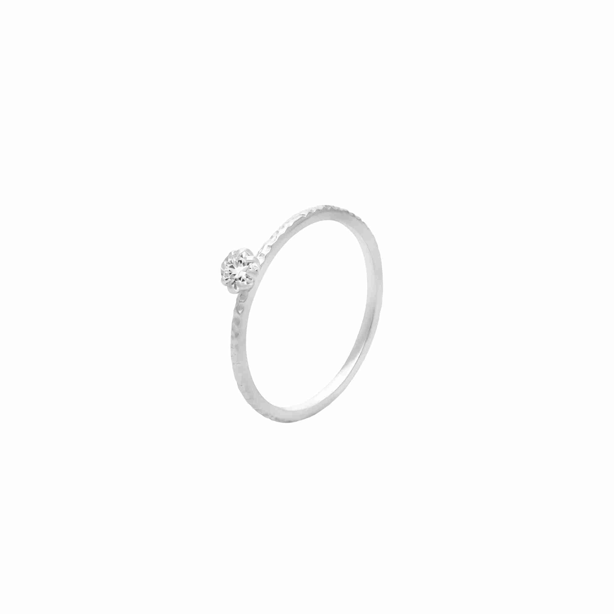 Protsaah Zurich - Kaleidoscope Aura White Topaz hand-hammered solitaire ring shown from an angled profile, crafted in recycled sterling silver, handcrafted sustainable gemstone jewelry Switzerland.