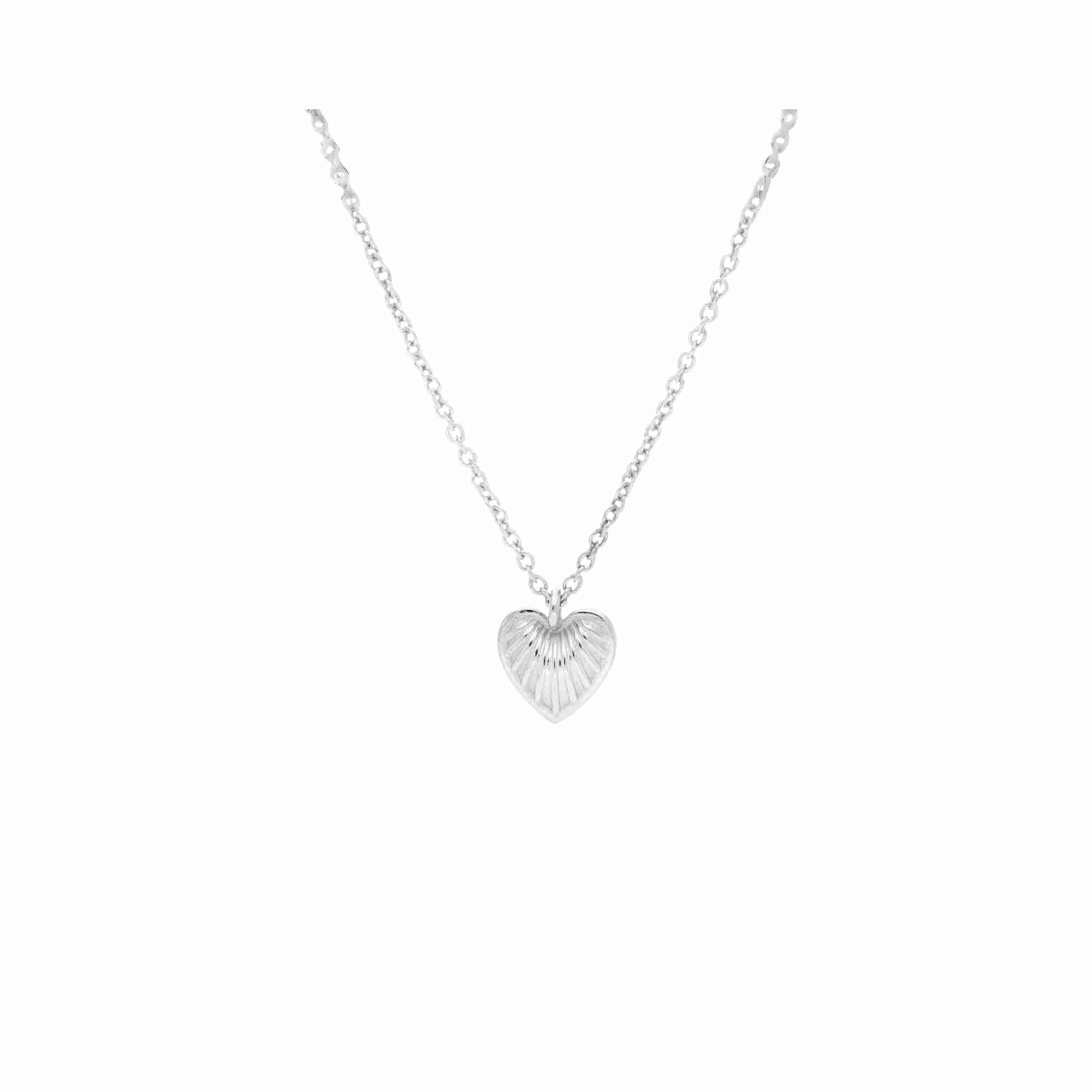 Front view of the Queen of Charms Fluted Heart Pendant Necklace in silver, showcasing the textured, ribbed starburst heart charm suspended on a fine link chain.