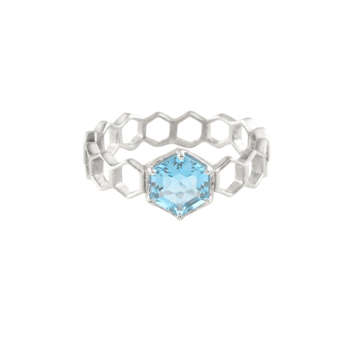 Hexagon-cut blue topaz in six silver claws at the centre of a honeycomb band ring on a white background
