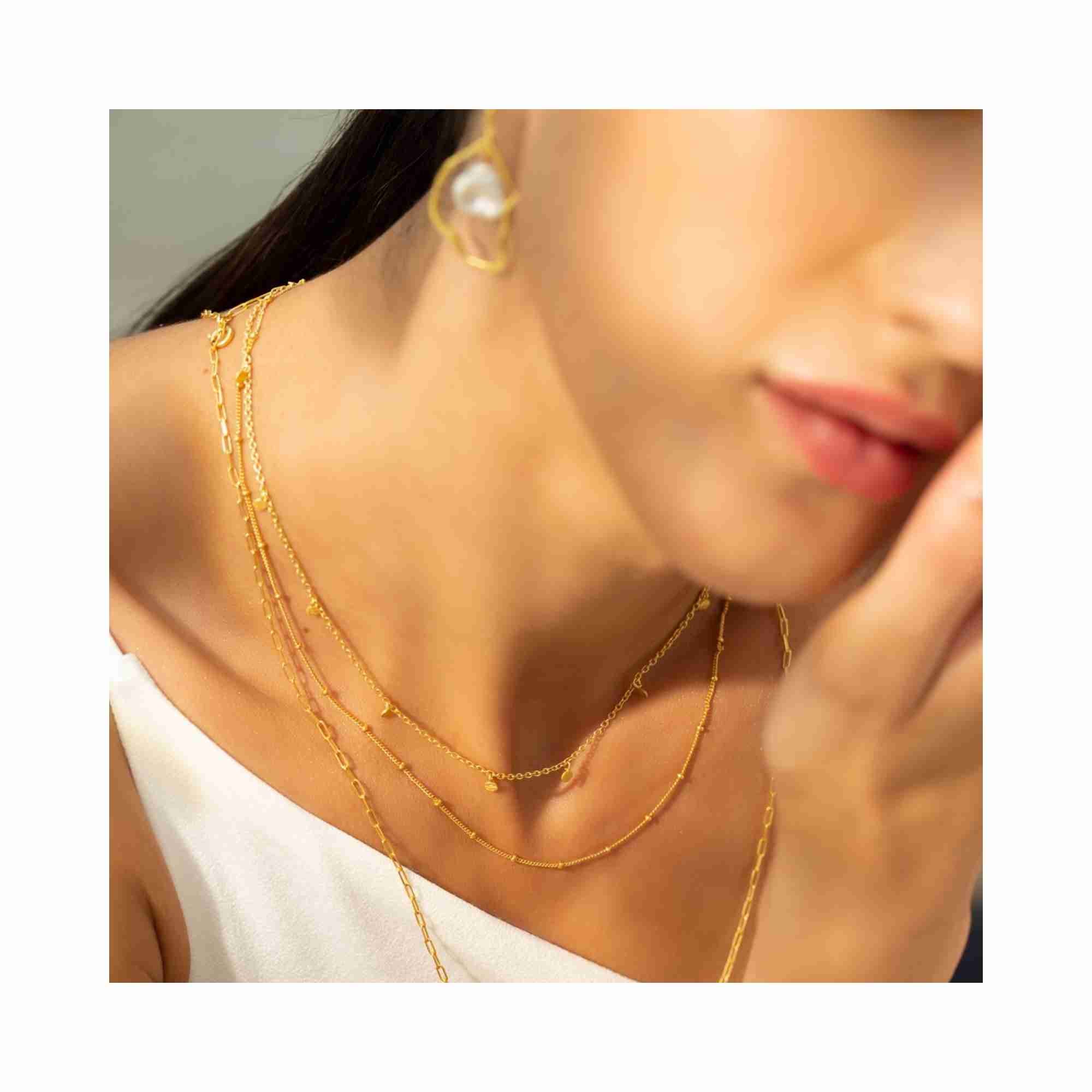 Detailed technical shot of the Shimmering Disks Constellation Disc Chain Necklace, focusing on the precision-linked gold disks and the signature matte-brushed luster of the 22K gold vermeil — Protsaah Zurich.