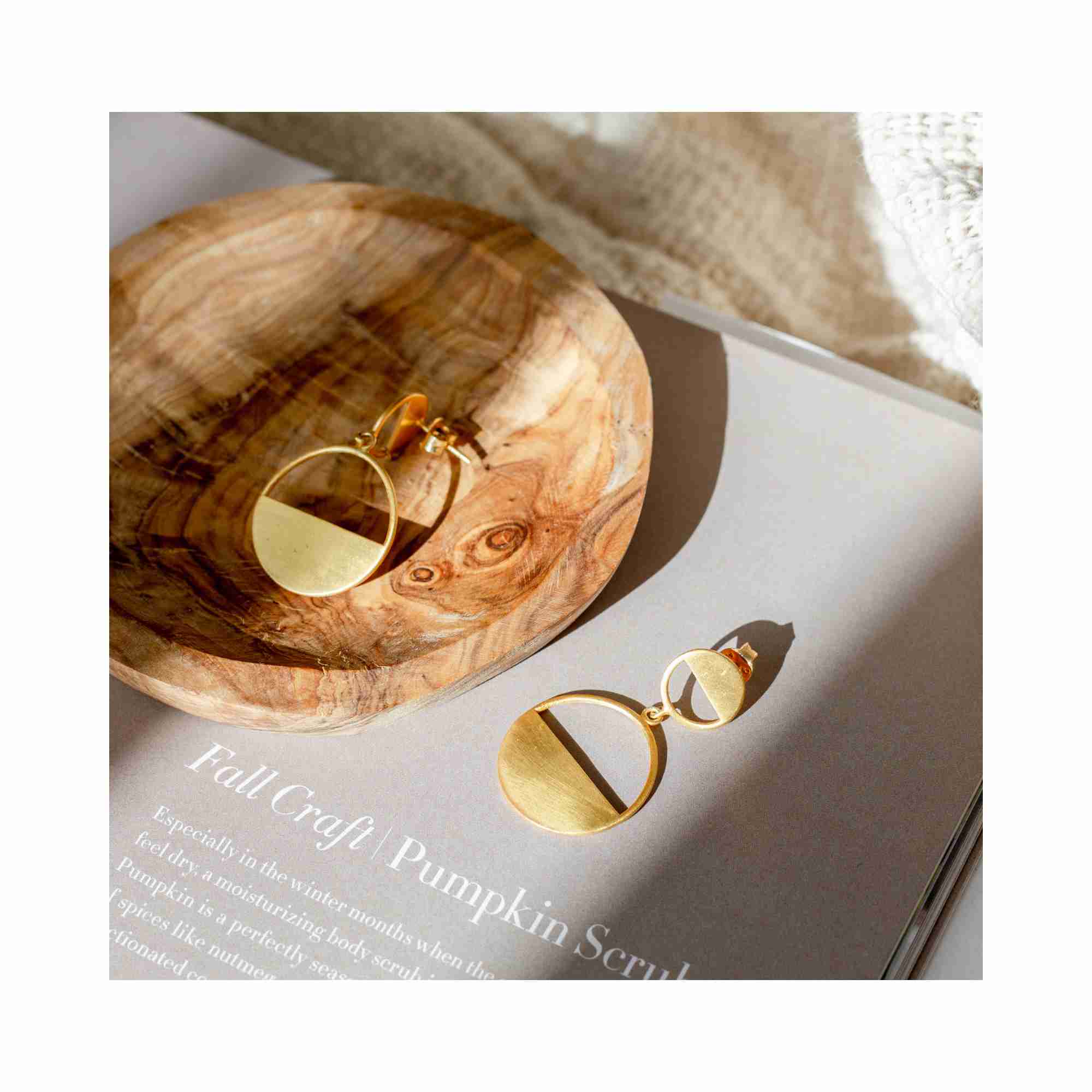 Editorial model photoshoot of Shimmering Disks Horizon Duo Drop Statement Earrings in 22K gold vermeil, featuring a bold two-tier circular silhouette styled for a sophisticated, modern look — Protsaah Zurich.