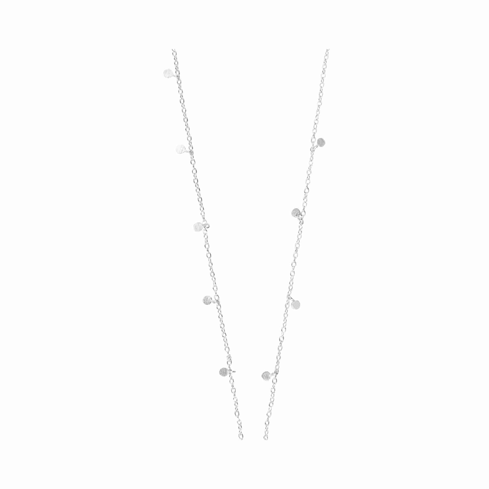 Editorial model photoshoot featuring the Shimmering Disks Constellation Disc Chain Necklace Silver, showcasing the minimalist layering of etched circular disks in 92.5 recycled silver for a contemporary, architectural look — Protsaah Zurich.