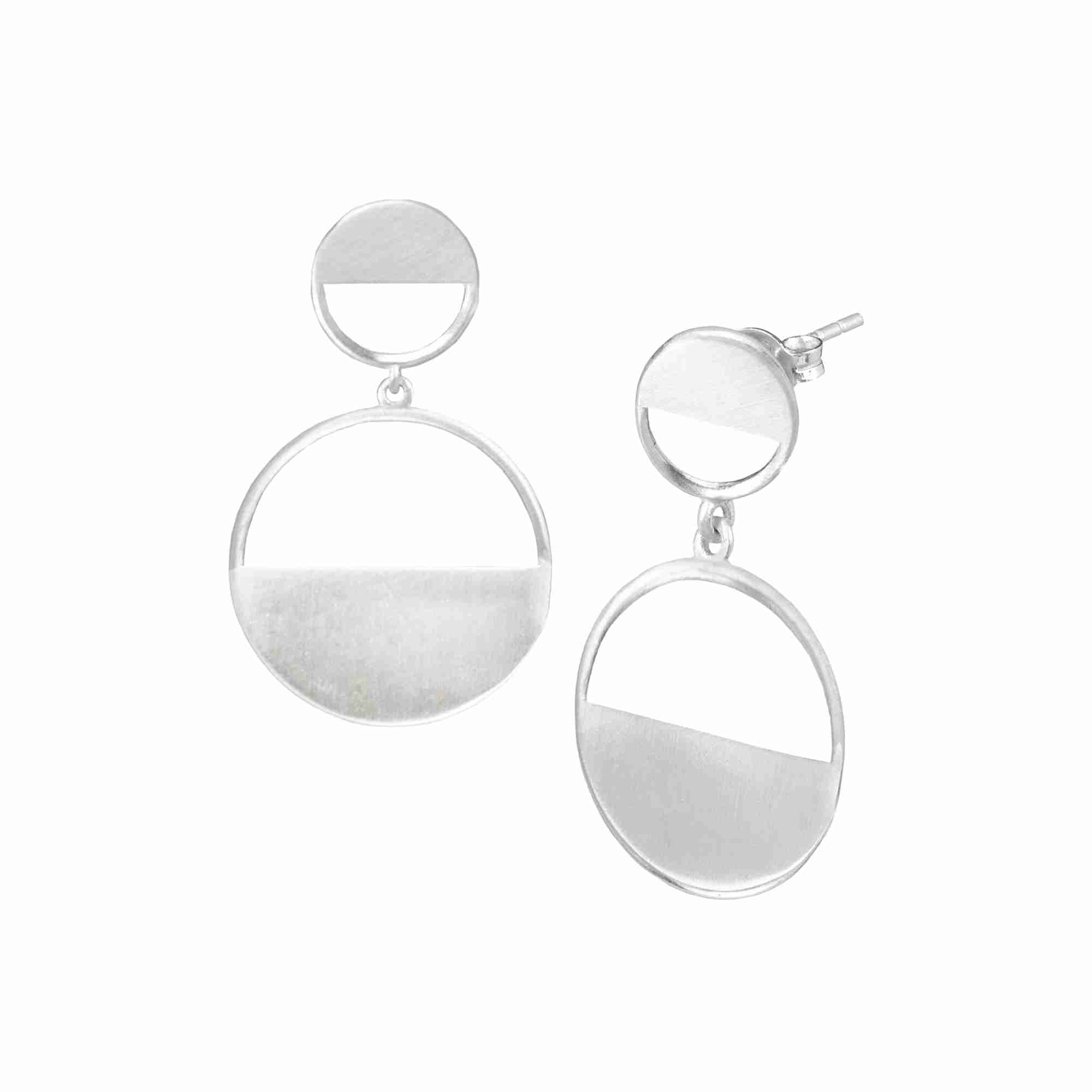 Shimmering Disks Horizon Duo Drop Statement Earrings in silver, styled on a rustic terracotta brick with green succulent accents to emphasize the organic and sustainable jewelry aesthetic — Protsaah Zurich.
