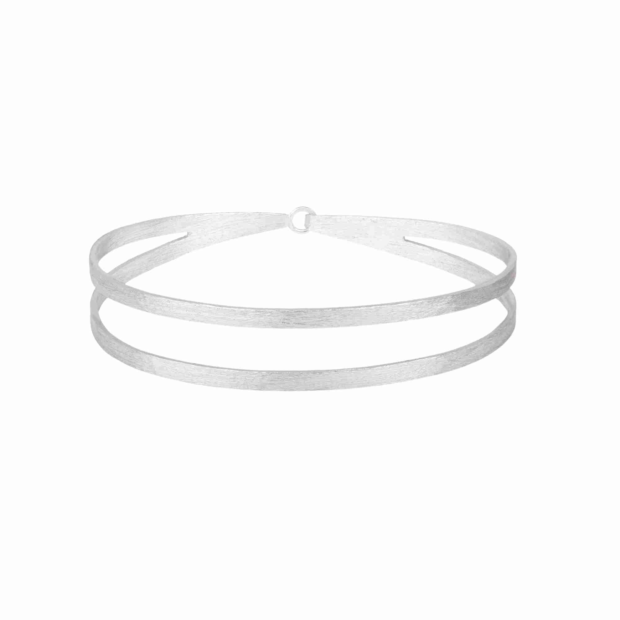 Studio product shot showcasing the Shimmering Disks Sculptural Flat-Band Double Cuff Silver against a plain white background; hand-brushed matte sterling silver open architectural double-band wristwear by Protsaah Zurich.