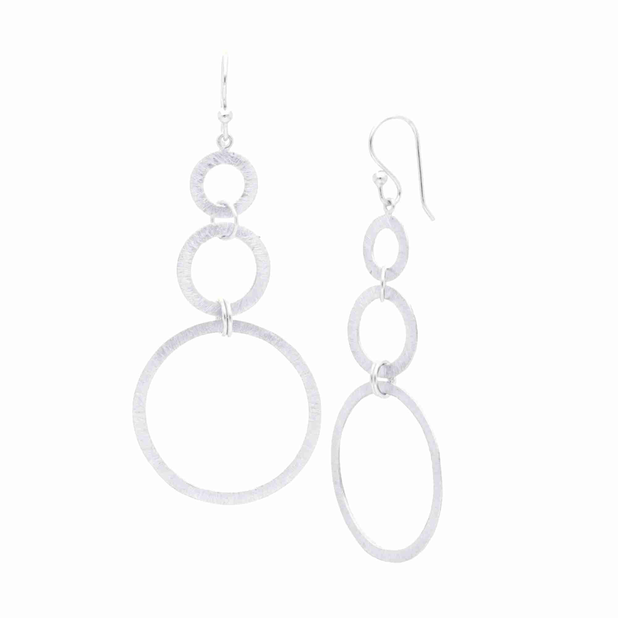 Shimmering Disks Triple Circle Cascade Statement Earrings Silver — three graduating open-circle rings with hand-applied cross-hatch scratch finish in 92.5 recycled silver by Protsaah Zurich.