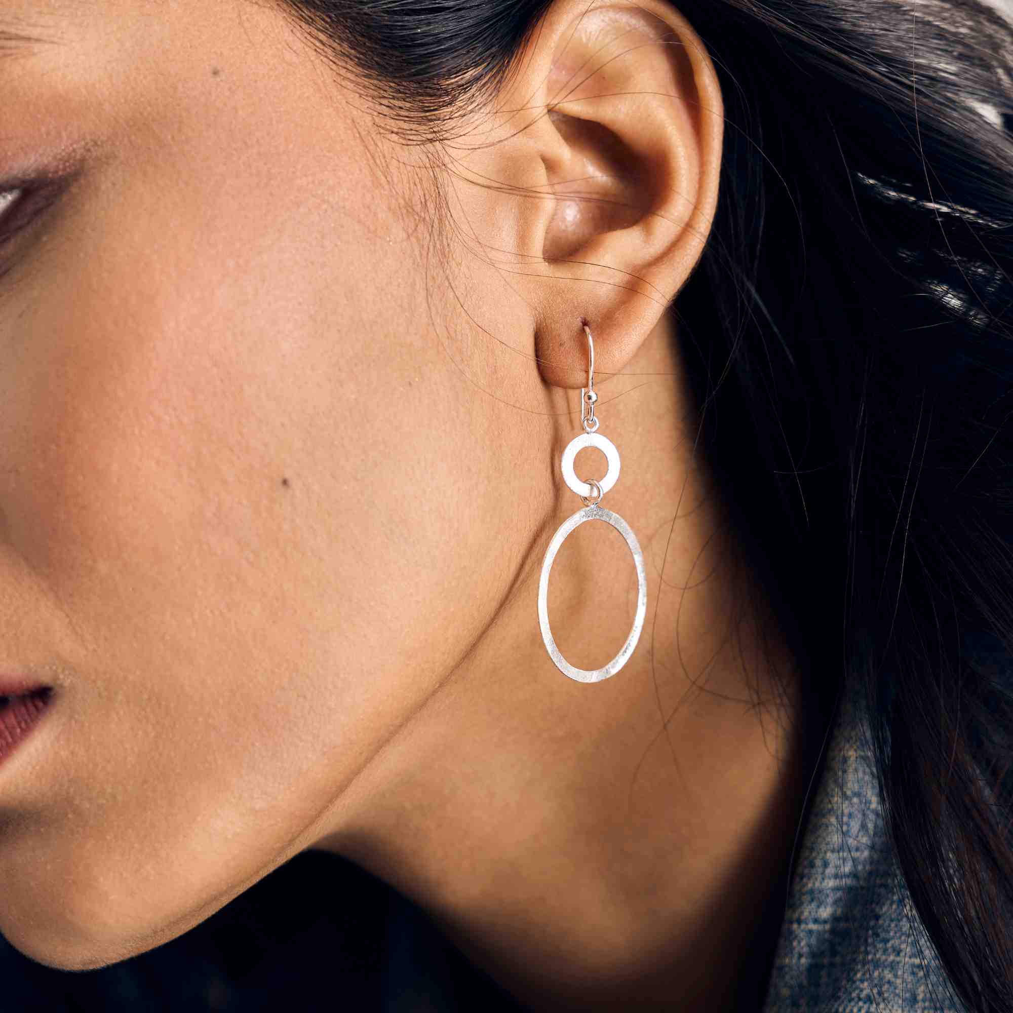 Shimmering Disks Dual Circle Sterling Silver Drop Earrings with cross-hatch scratch finish, handcrafted in Tibet by PROTSAAH — side profile model shot